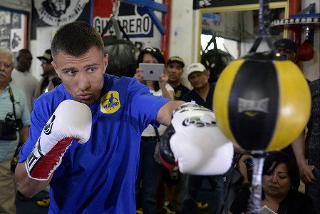 Vasyl Lomachenko and Garry Russell Jr. battle it out for the vacant WBO featherweight title